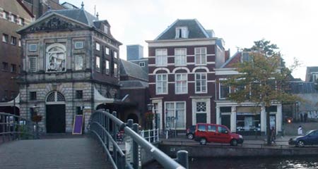 View from the bridge of Aalmarkt 17 + the medival weighing house in Leiden.